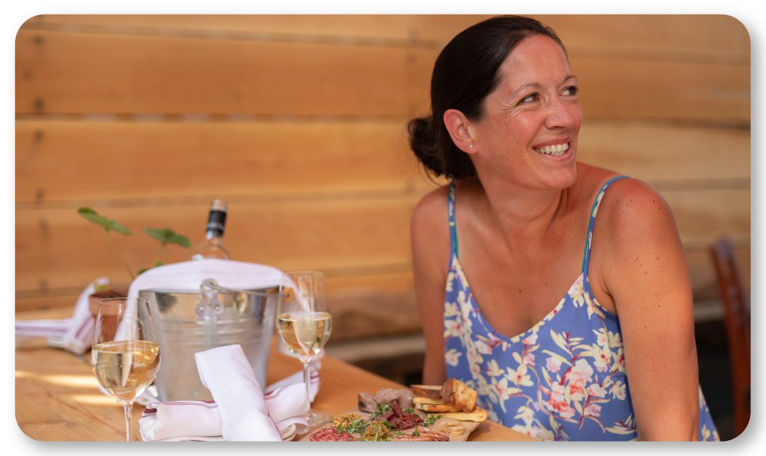 woman at table with wine bucket